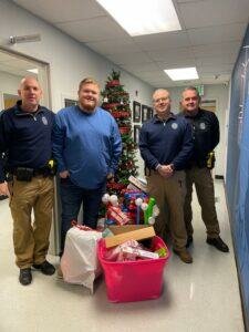 Columbia police officers posing next to toy donations they received. 