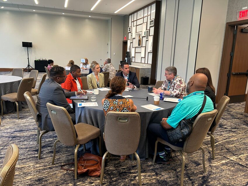 Superintendent Jason Faulkner participates in a roundtable discussion about data-driven analysis to identify and address issues in the school system.