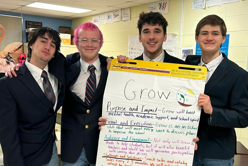 Hunter Hendren, Colten Gravel, Ethan Dial and Gabe Spillman show off their GROW poster that helped secure them a first place win in regionals.