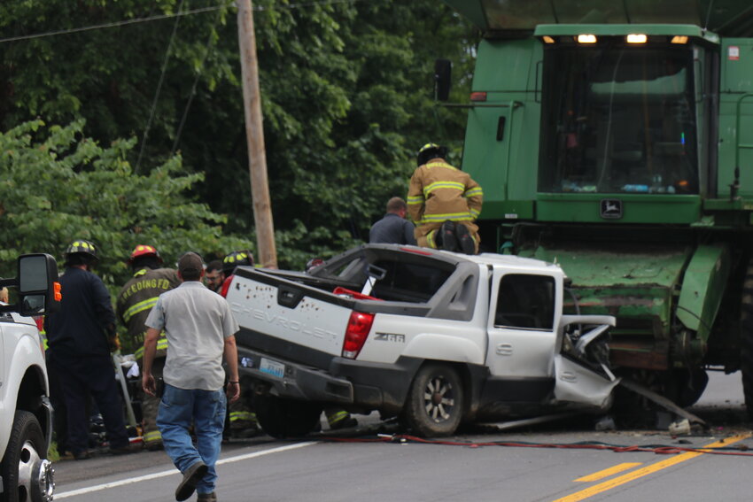Emergency services were on the scene for several hours Monday during a successful extrication rescue when the driver of a truck was entrapped under a combine.
