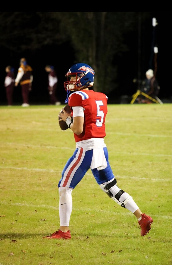 Quarterback Easton Jessie preparing to pass the ball.