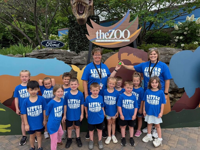 Front row from left, Harry Lim, Daya Creason, Ezra Spoon, Daryl Peters, Nova Morey, Drake Peters, and Katie Neal. Back row from left, Skylar Cotter, Rory Scott, Robert Wilkerson, Montgomery Lawhorn, and Kinsley Comstock with Tonya Feese and Tabitha Coppage, teachers posing in front of display at the Louisville Zoo.