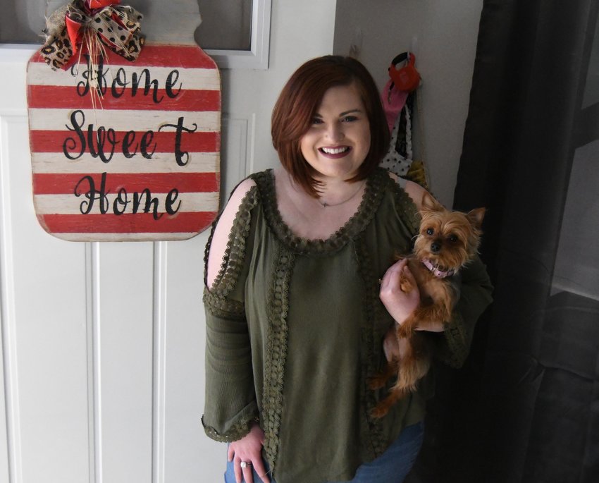Tori Shiers and her dog, Phoebe, stand in the entryway to her tiny home in The North Village. Shiers moved into the 460 square-foot residence in October.