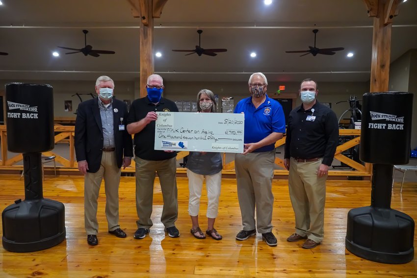 The Mruk Family Education Center on Aging recently received a donation from the Knights of Columbus for the Rock Steady Boxing program. Sown above are (from left) Barney Larry, Paul Mruk, Diahanne VanGulick, Tom Kaster and Justin Woods.