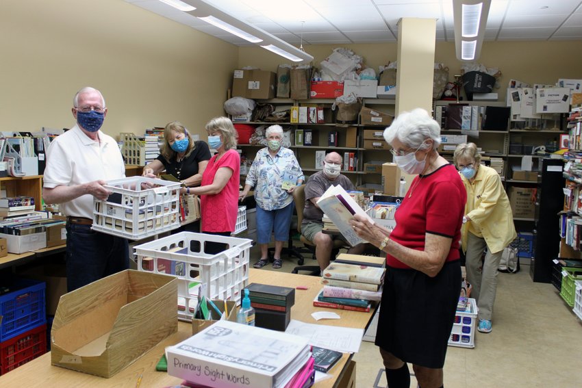 Volunteers with the Friends of the Library at work preparing for the upcoming Used Book Sale.