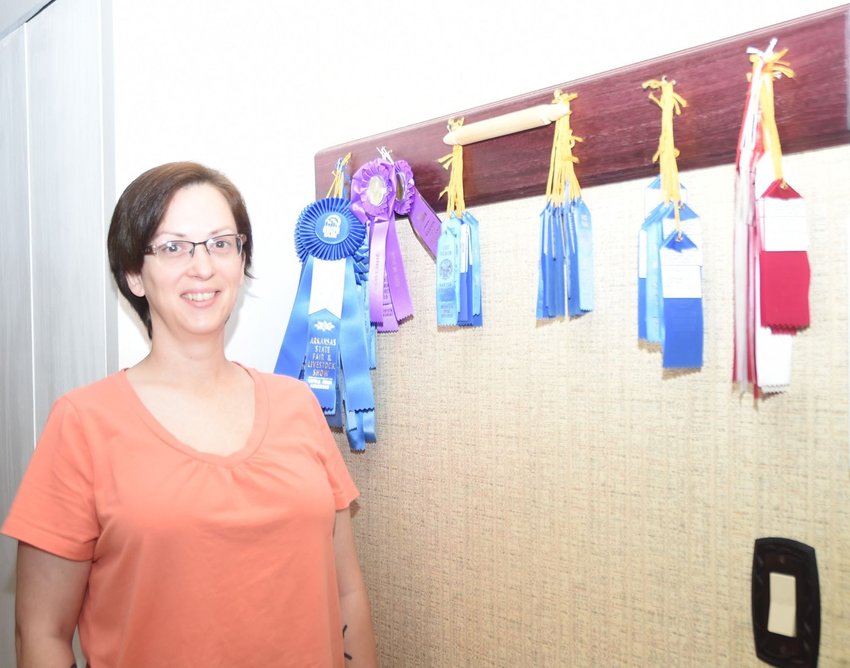 Emily Lancaster of Mountain Home shows off the numerous ribbons she has won for her baking from the Baxter County Fair, the Northwest Arkansas District Fair and the Arkansas State Fair and Livestock Show.