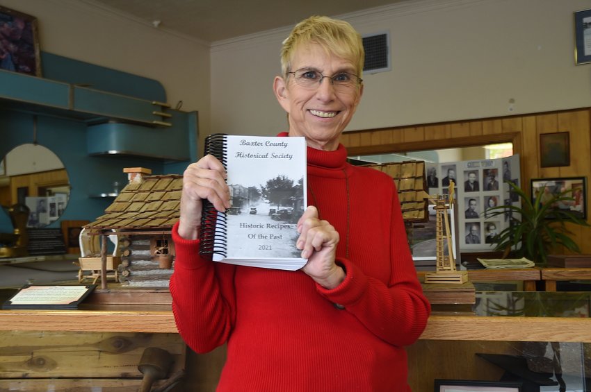 Baxter County Historical Society board member Jennifer Baker displays a copy of the group's new cookbook. 'Historic Recipes of the Past,' has been the group's only fundraiser since the COVID-19 pandemic.