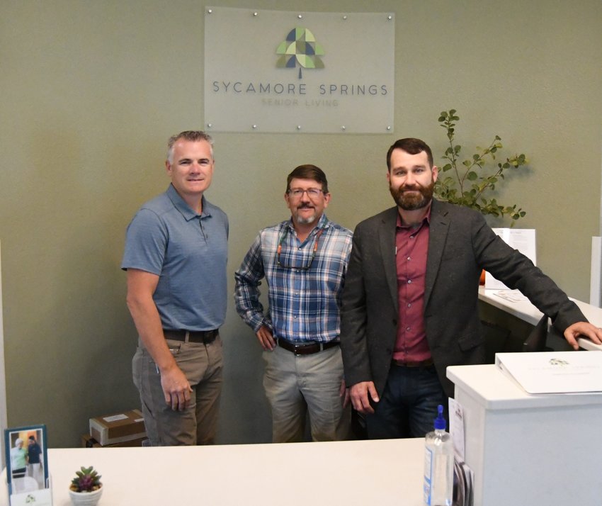 Sycamore Springs Senior Living co-owners (from left) Lance Gross and Dr. Tim Paden stand behind the facility's front desk with Executive Director Nick Arnold. Sycamore Springs, located at 165 Jerry Baker Lane in Mountain Home, opened about a month ago.