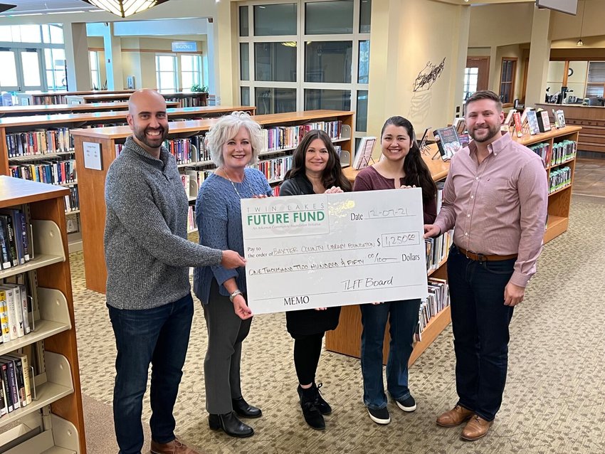 Presenting a $1,250 grant to Baxter County Library for its early literacy project are (from left) Phillip Frame, Twin Lakes Future Fund committee member; Kimberly Jo, Twin Lakes Community Foundation executive director; Kim Crow Sheaner and Mariah Hansen of Baxter County Library and Wes Woods of the Twin Lakes Future Fund.