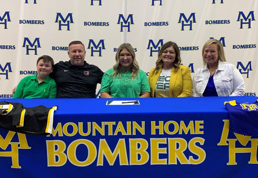 Mountain Home cheerleader Aubrey Williams signed Friday her National Letter of Intent with Arkansas Tech University in Russellville. Pictured at her signing are (from left) Ben Williams, Jason Williams, Aubrey Williams, Summer Williams, and MHHS cheer coach Keri Mahan.