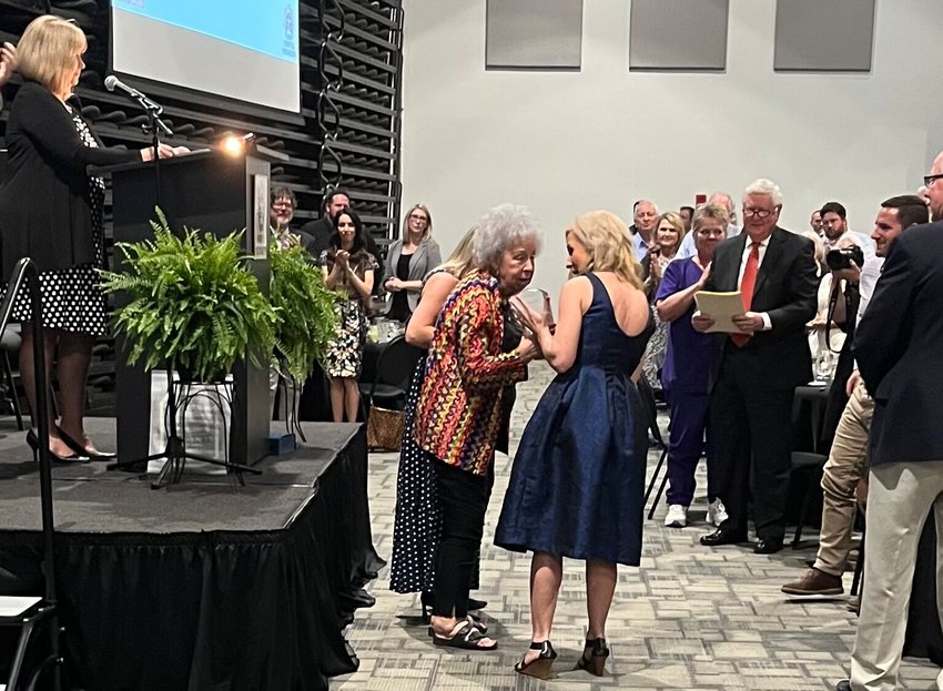 Life-long Mountain Home resident and Baxter Regional Medical Center volunteer Jeannie Alley (center) was honored Thursday night by the Baxter Regional Hospital Foundation for donating the gift of music to the facility. In 2019, Alley donated her Baldwin grand piano and established a music ministry at BRMC in memory of her parents, long-time Baxter County residents Don and Clema Alley. Alley can be found playing every weekday from 10 a.m. until noon.   Helen Mansfield/The Baxter Bulletin