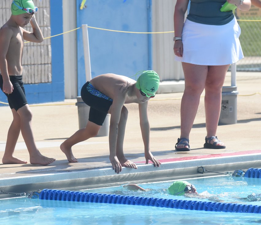 Mountain Home Hurricane swimmer Parker Kohler awaits his turn during a medley relay event recently at Cooper Park.