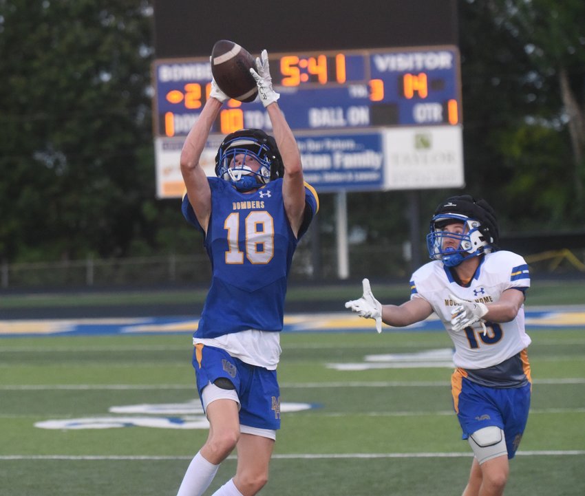Mountain Home receiver Talan Palmer (18) makes a jumping catch during Friday night's scrimmage at Bomber Stadium.