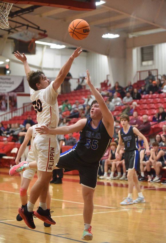 Flippin's Gabe Davis rejects a shot by Ozark Mountain's Ethan Brumley on Tuesday night.