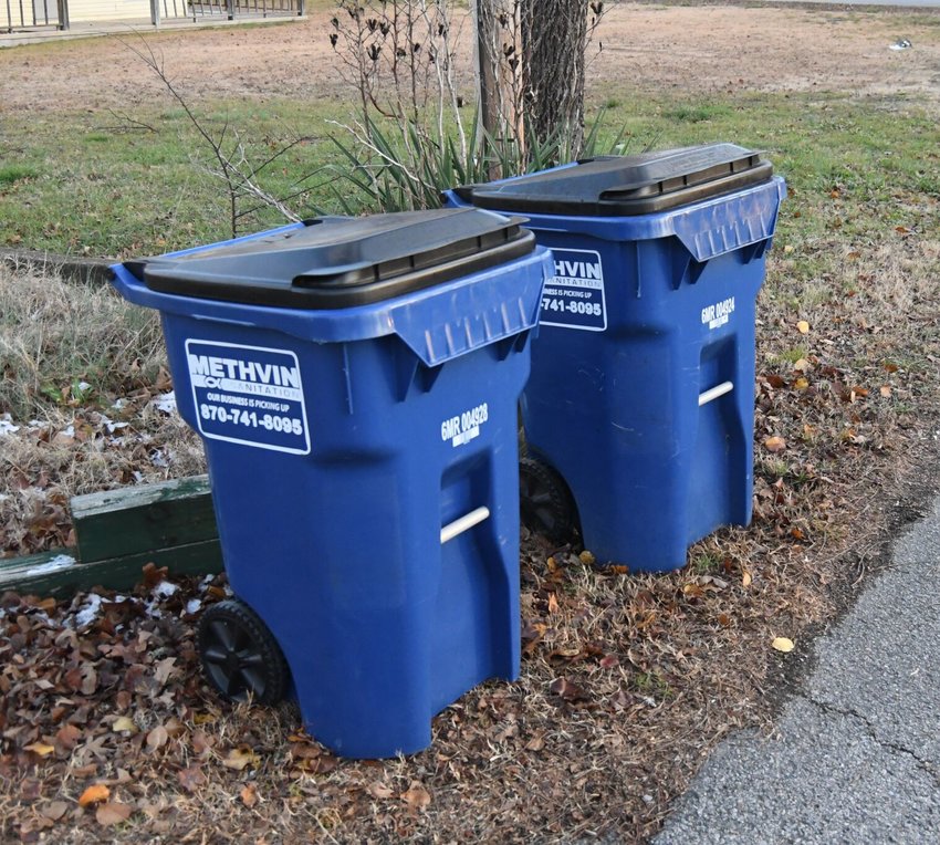 A pair of Methvin Sanitation-branded trash cans sit out at the curb to be picked up in Mountain Home. Methvin Sanitation is selling its business to Waste Connections, which will take over operation of the city's residential trash pickup service.   Bulletin File photo