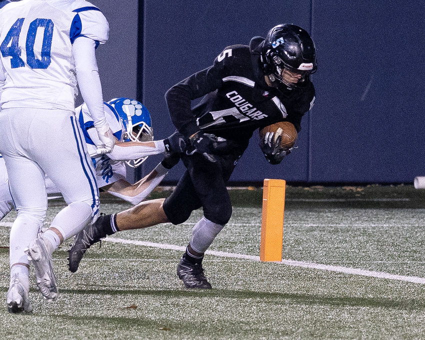 Izard County's Malachi Cruz reaches for a touchdown during his team's state championship victory over Rector on Thursday night at War Memorial Stadium.