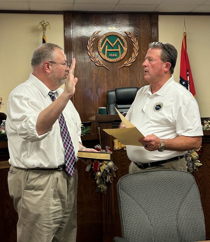Mountain Home City Clerk Scott Liles (left) is sworn into office Thursday night by Mayor Hillrey Adams. Liles will hold the office through Jan. 31 to complete the term of former City Clerk Brian Plumlee, then begin his own four-year term in office on Jan. 1.   Submitted Photo
