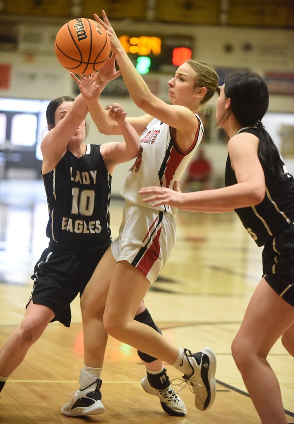 Flippin's Ella Alexander battles two Cossatot River players for a rebound on Saturday at West Fork.