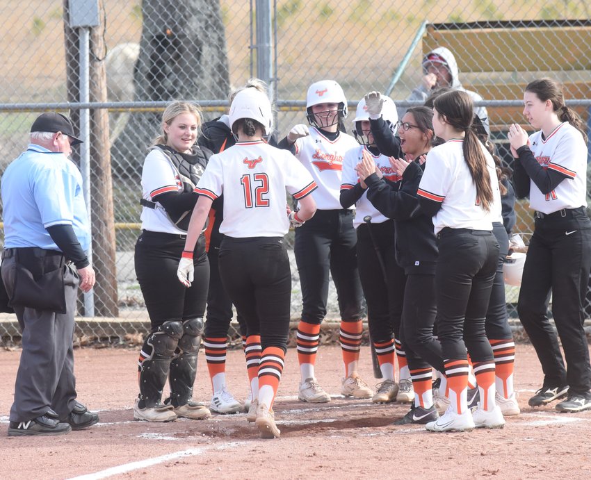 Viola's Haylee Crotts (12) is congratulated at the plate by teammates after hitting her third homer of the season on Wednesday against Flippin.