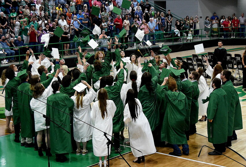 Yellville-Summit graduates toss their mortarboards after graduating from the school on Friday evening.
