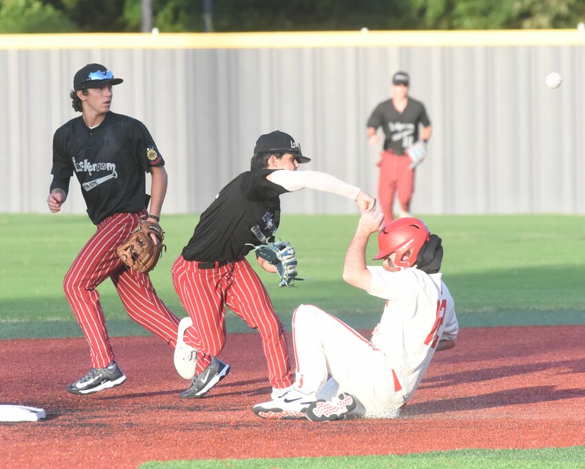 Lockeroom shortstop Philip Pasthing throws to first as he and second baseman Lincoln Sherry (left) try to turn a double play against Cabot on Friday.