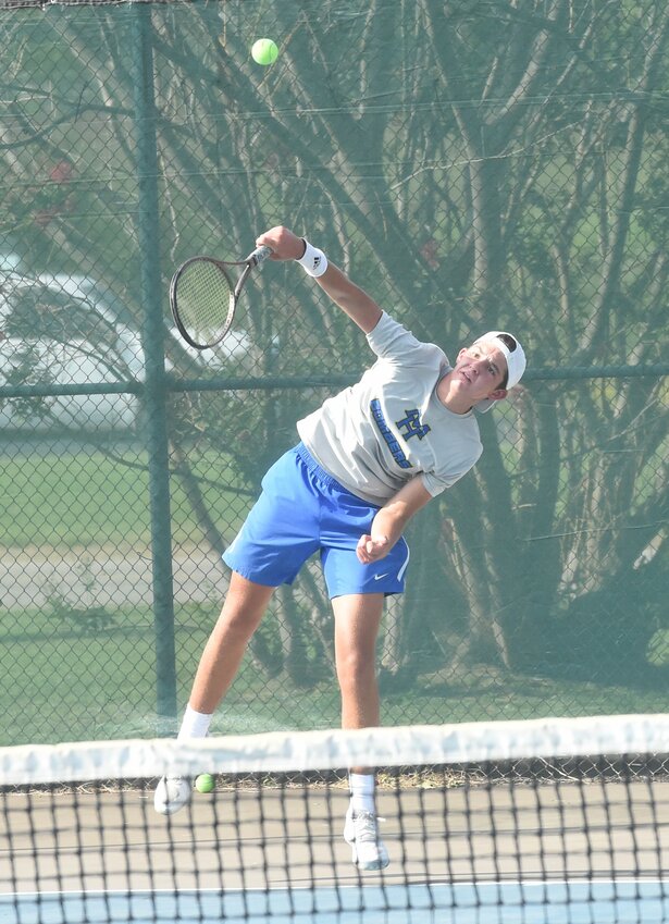 Mountain Home's Stratton Smith serves during a recent home match.