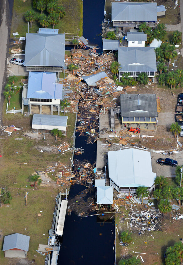 A large pile-up of storm debris is seen in a canal in Horseshoe Beach, Fla., on Thursday, Aug 31, 2023, following Hurricane Idalia’s landfall in Keaton Beach, Fla., Wednesday morning. (Caleb Ross/WUFT News)