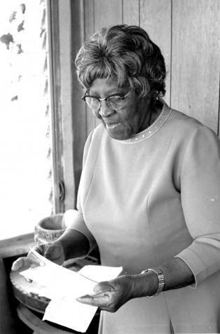 Minnie Rogers looks over documents. Date unknown.