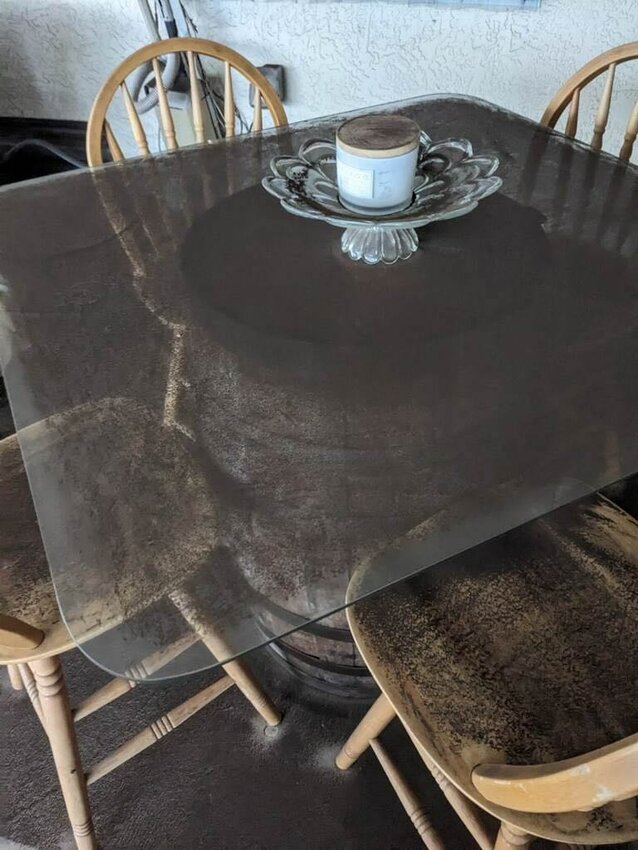 Manatee County resident Carolyn Alvarez shows what her patio furniture looked like after a wind storm carried dust from a nearby development site. photo by: Carolyn Alvarez