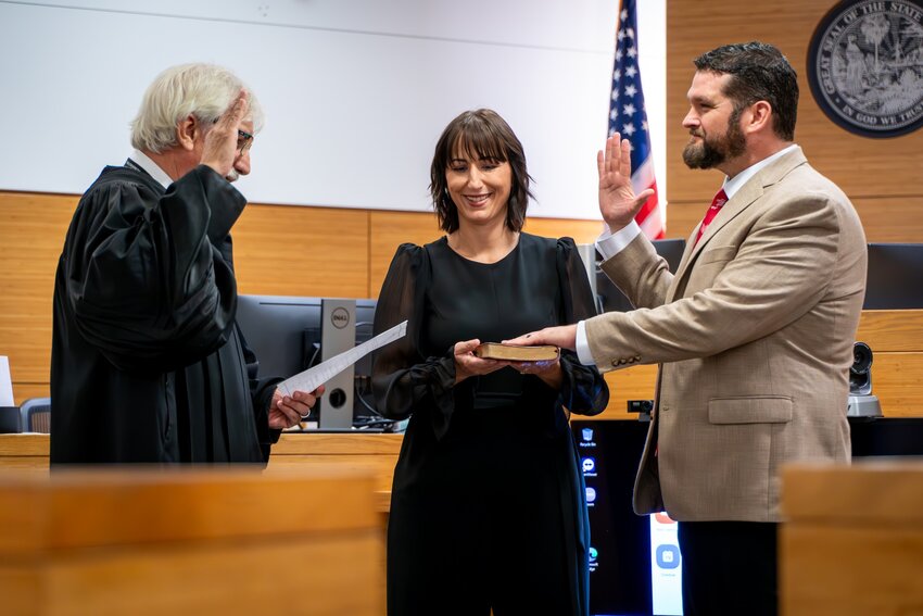 James Satcher is sworn into the office of Manatee County Supervisor of Election by Judge Gilbert A. Smith Jr. on April 16, 2024. Satcher's wife, Monica Satcher, holds the bible.