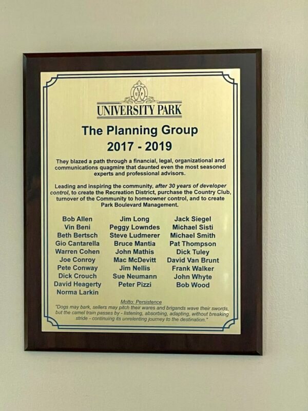 The names of residents who helped form the recreation district, known as the elders, are engraved on a plaque hanging on the wall of the University Park Country Club.