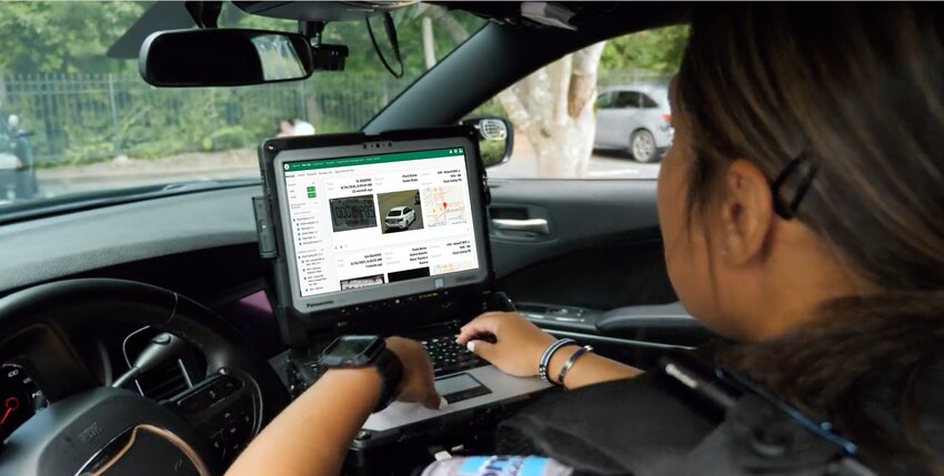 Promotional image from Flock Safety showing a law-enforcement officer using the system from inside a patrol car. | Photo courtesy of Flock Safety