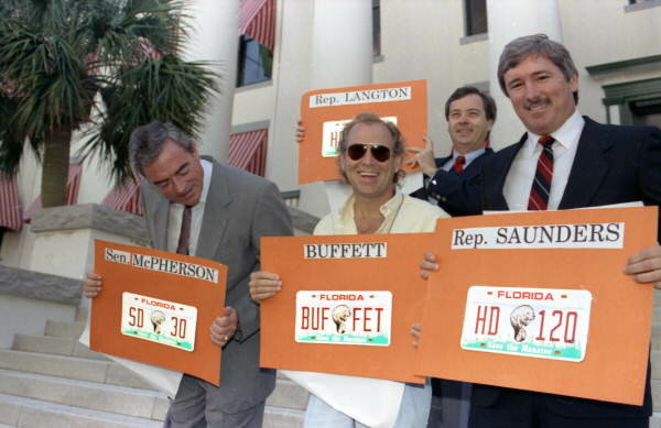 Jimmy Buffett with legislators holding Save the Manatee license plates