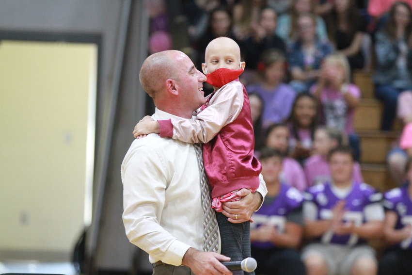 Jason Pursley and Lyndsey Morales hug after she shaved his head at the Skyline assembly on Friday. Pursley is principal of Skyline Elementary School.