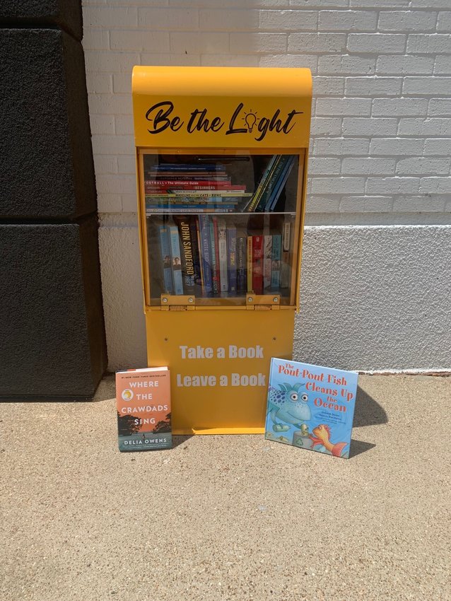 The brightly painted &ldquo;Little Library&rdquo; box contains a variety of books available on the honor system.