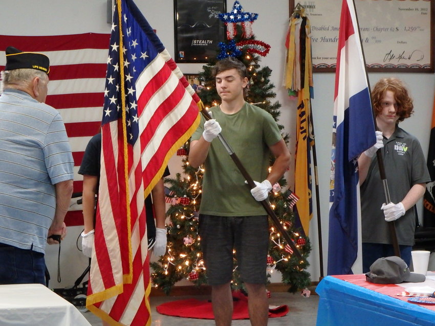 Ethan Richard holds the American flag, and Grant Schnapp holds the Missouri flag.