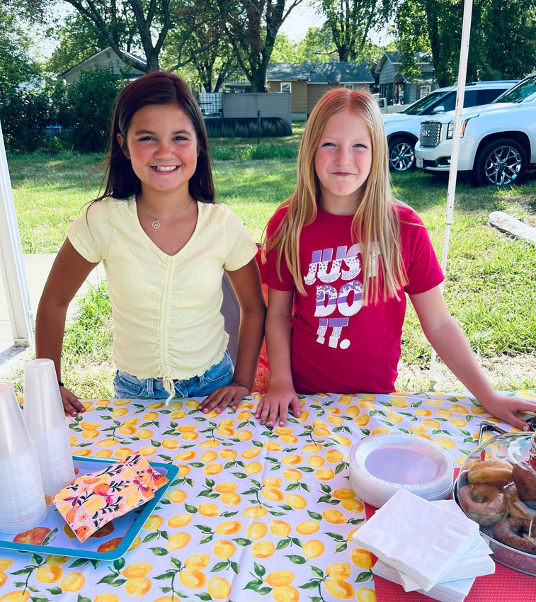 Khloe Kramer, left, and Tenley Jasper raised $244 with their lemonade stand for the school lunch program.