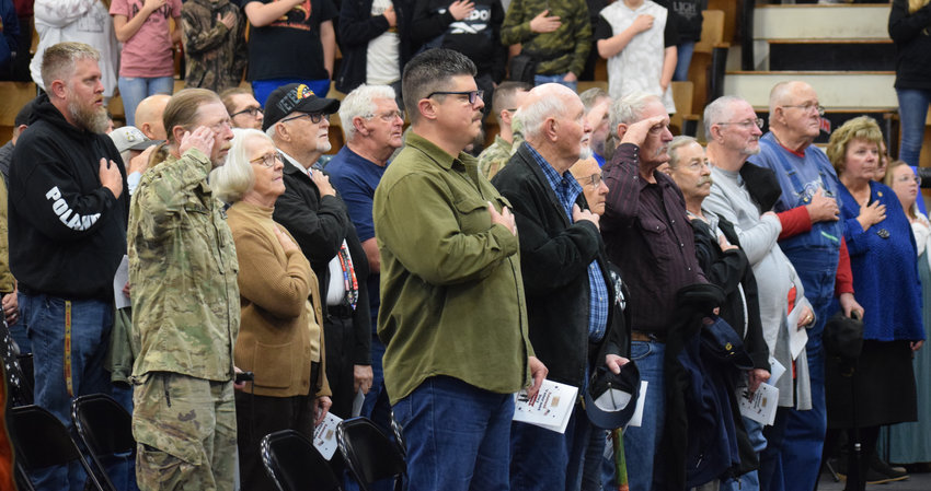 Veterans and students respectfully faced the American flag as the pledge was recited and the national anthem played at the Buffalo High School and Middle School assembly Friday, Nov. 11, in the field house on the BHS campus.