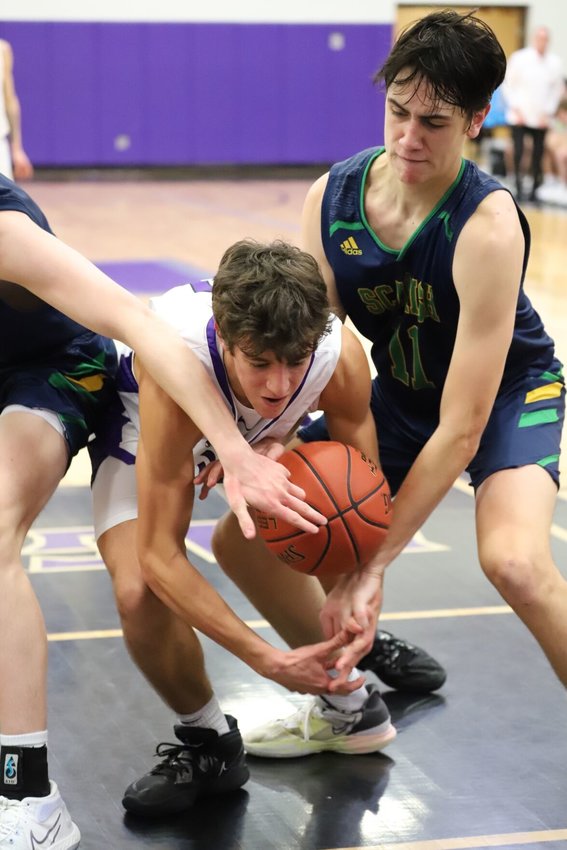 Nolen Geitz (in white shirt) fights for the ball with two Springfield Catholic opponents.   Reflex photo by Melissa Green