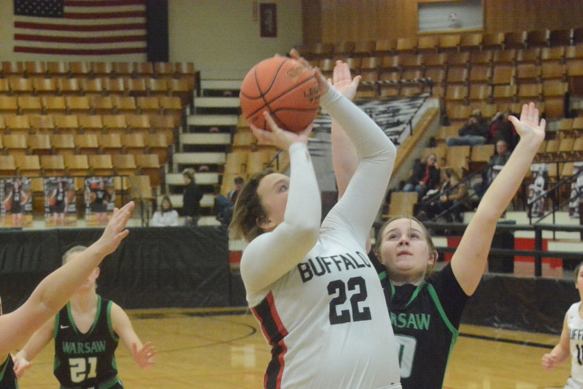 Raegan Carter goes up strong for two points against Warsaw.   Reflex photo by Paul Campbell