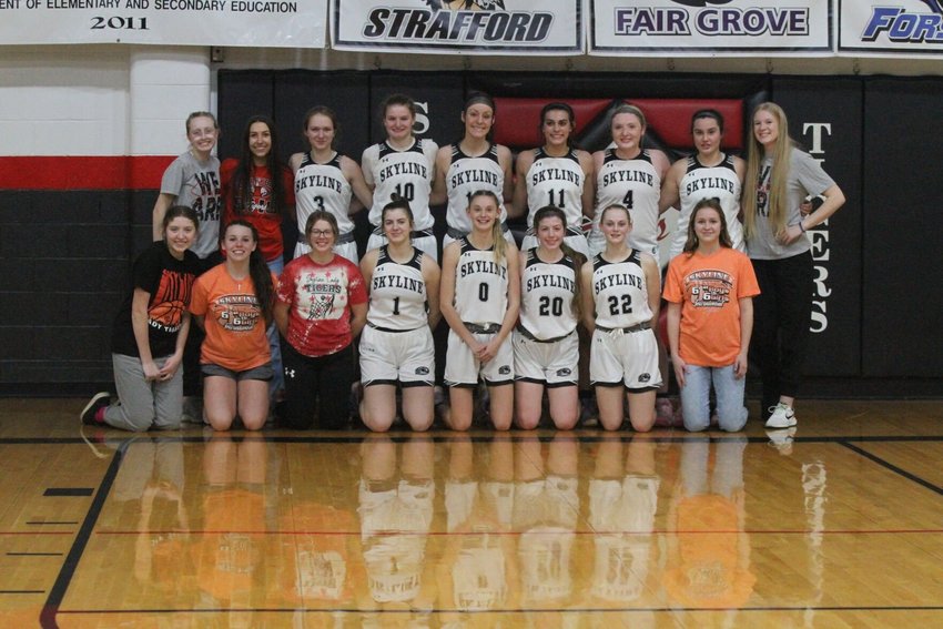 The Skyline Lady Tigers celebrate their Mid-Lakes Conference championship that they won by defeating Strafford on Monday night 60-55.   Reflex photo by Kelli Cheek