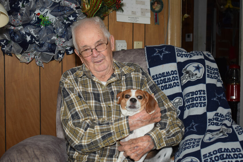 Jim Hyatt is a retired law officer of Buffalo and Dallas County, and before 1989, Wichita, Kan. His pet pooch, Missy, poses for the photo with him.   Reflex photo by Steve Johnson