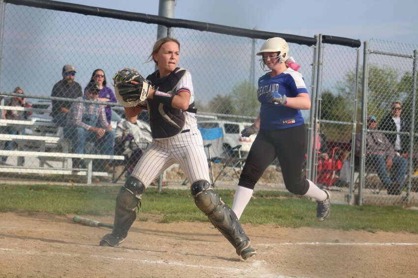 Freshman catcher Brooklyn Righter touches home plate for the force out and looks to throw to another base against Wheatland.   Photo courtesy of Aleia Ream