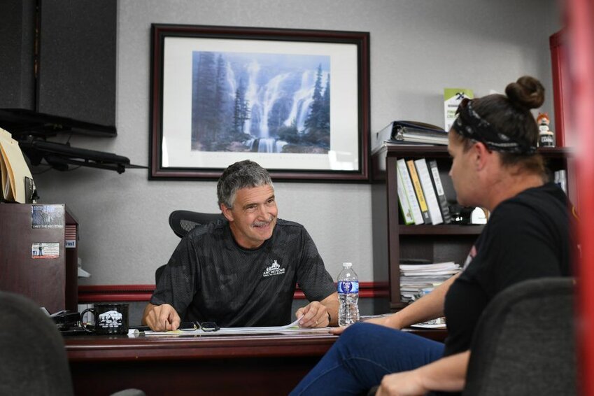 Brian Ainley talks to Quari LaRoe in his office on June 9, 2023 at ABC Motors in Buffalo, MO.