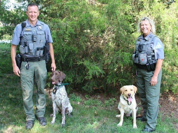 Corporal Andrew Feistel and Titan (left) and Corporal Susan Swem and Astro (right) are members of the Missouri Department of Conservation's canine unit that will be at this year's Ozark Empire Fair.