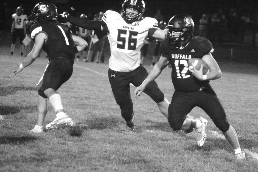 Brad Mankey (12) was illusive all night, and here Skyline lineman Wyatt Stoner (56) tries to track him down. Also pictured is Buffalo quarterback Isaiah Young (1). Mankey gained 98 yards on the ground and scored two touchdowns.