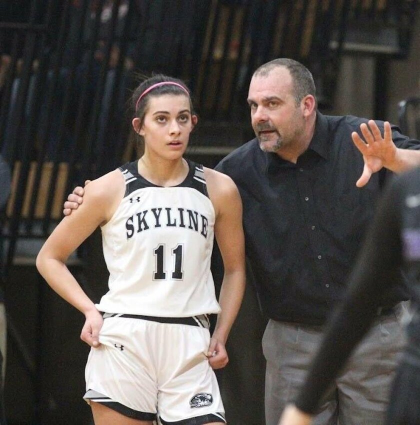 Kevin Cheek gives instructions to his daughter, Kenzi, during a game.