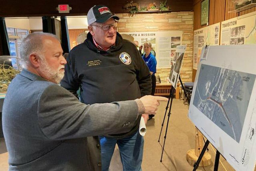 Dallas County Commissioner John Crawford listens to Bud Sherman, MoDot Project Manager, as he describes the plan for the $13.7 million Dallas County bridge replacement at Bennett Spring.