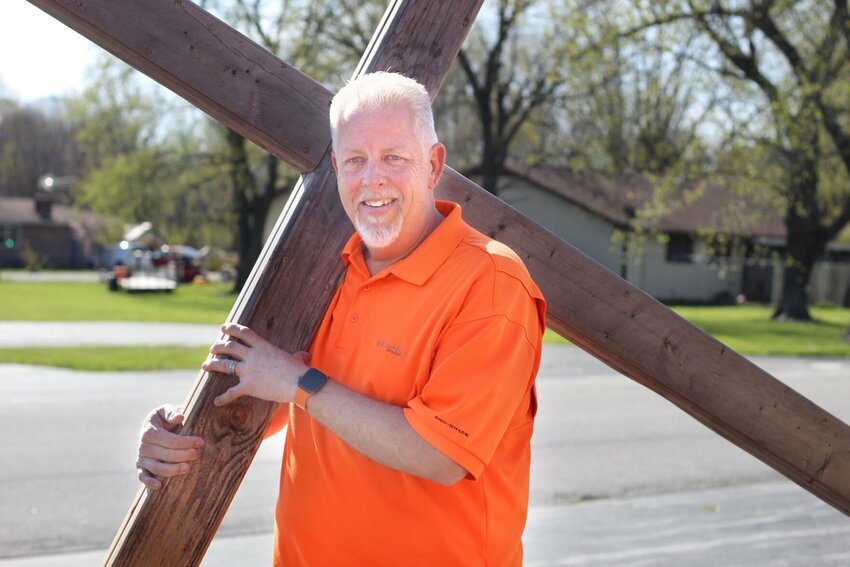 Tim Wright is the new pastor at First Assembly of God in Buffalo. Here he carries a cross he made for his annual Easter walk on Good Friday.