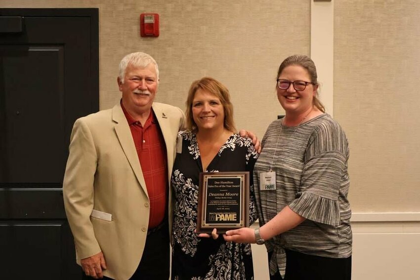 Deanna Moore, center, is flanked by Jim Hamilton and his daughter, Melissa Saner who presented Moore with the prestigious Dee Hamilton Memorial Sales Pro Award at the annual Missouri Press Advertising &amp;amp; Marketing meeting held in Branson.